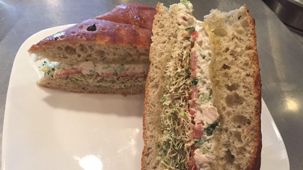 Chicken Salad Focaccia · Chicken salad with swiss cheese, tomato, greens, and basil aioli.
