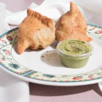 Vegetable Samosa (2 Pieces) · Flakey pastry filled with seasoned chickpeas, potato, cabbage and lentils.