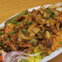 Chicken Shawarma Platter · Served with tomatoes, onions, garlic sauce, pitas, two rice, and side house salad.