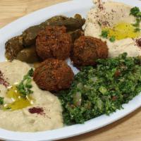 Vegetarian Plate · Hummus, baba ghanouj, tabouli salad, 3 falafels, and 3 grape leaves with two pitas.