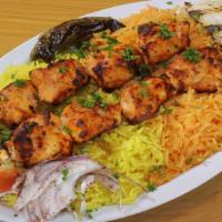 Chicken Kabob Plate · 2 Skewers On a bed of Yellow and Red rice. Includes char-grilled tomato and onion, hummus, h...
