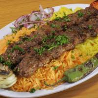 Kufta Kabob Plate · 2 skewers. On a bed of yellow rice and spicy red rice. Includes char grilled tomato, onion, ...