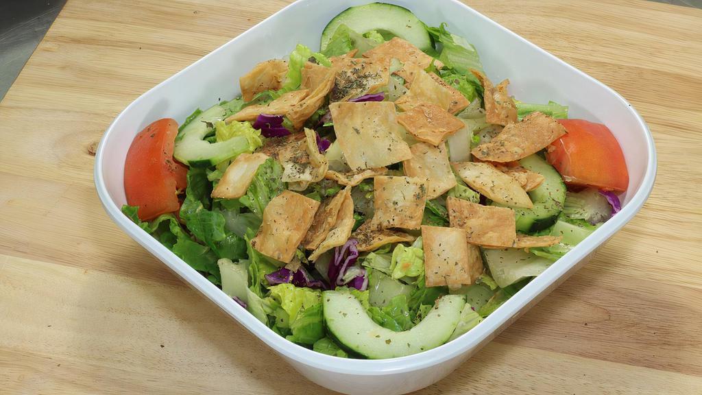 Fattoush Salad · Lettuce, tomato cucumber, green pepper, red cabbage, fresh mint, pita chips, lemon and olive oil.