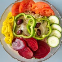 Greek Salad · Crisp lettuce tomato, onion, beets, feta cheese, green pepper, green olives and banana peppe...