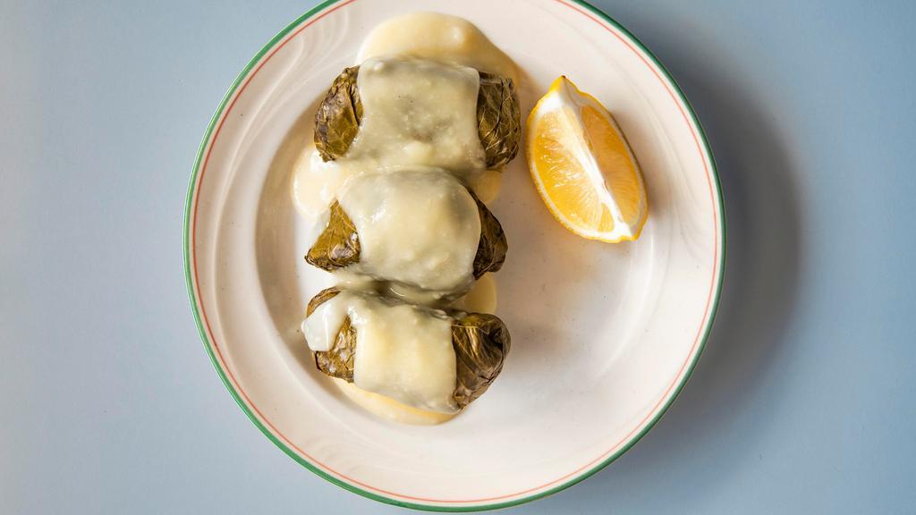Stuffed Grapeleaves Dinner · Three marinated grapeleaves filled with a fabulous blend of ground beef, rice and onions topped with a luscious lemon sauce.
Choice of two sides.