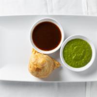 Vegetable Samosa (2) · Deep fried pastry stuffed with spices potatoes and peas.