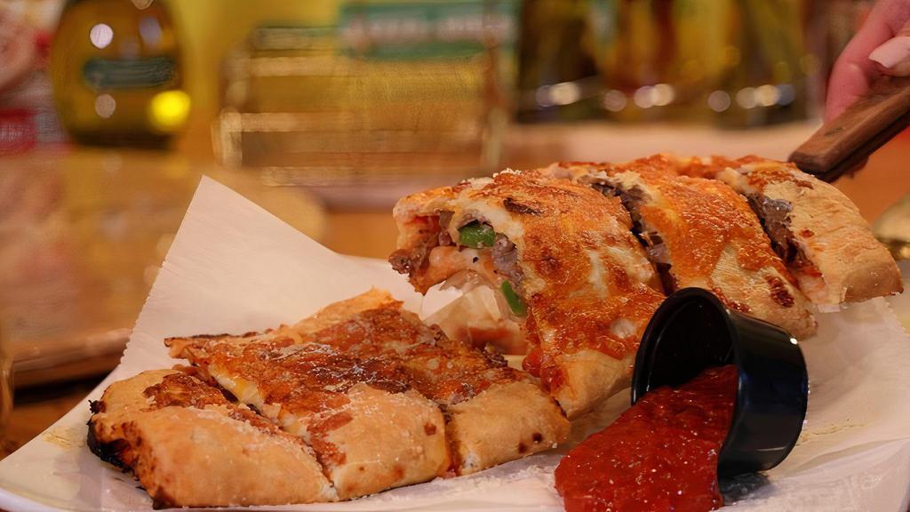 Philly Cheesesteak Calzone · Philly cheesesteak, green pepper, onion, olives and mushrooms.