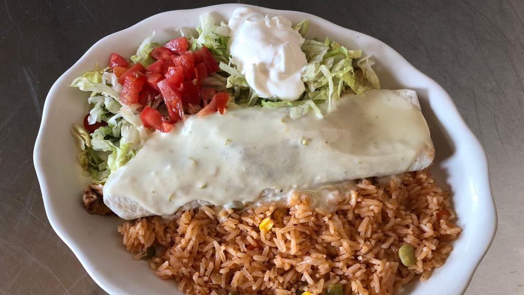 Burrito Fajita · Choice of fajita-style chicken or beef topped with nacho cheese, lettuce and sour cream. Served with rice.