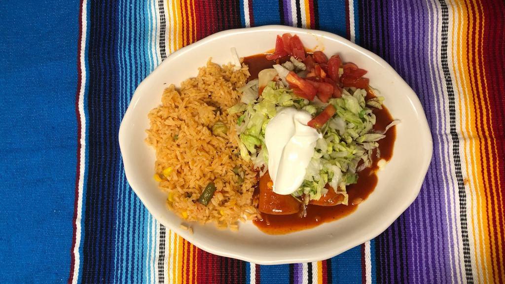 Lunch Special No. 6 · Two chicken enchiladas with rice, topped with lettuce.