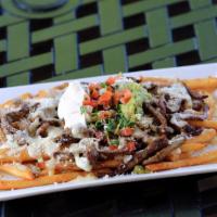 Carne Azada Fries · thick butterbeer fries topped with carne azada steak,guacamole,cotija cheese ,sour cream,pic...