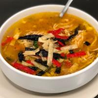 Sopa De Pollo · Chicken broth with rice, chopped tomatoes, onions, peppers, and cilantro.