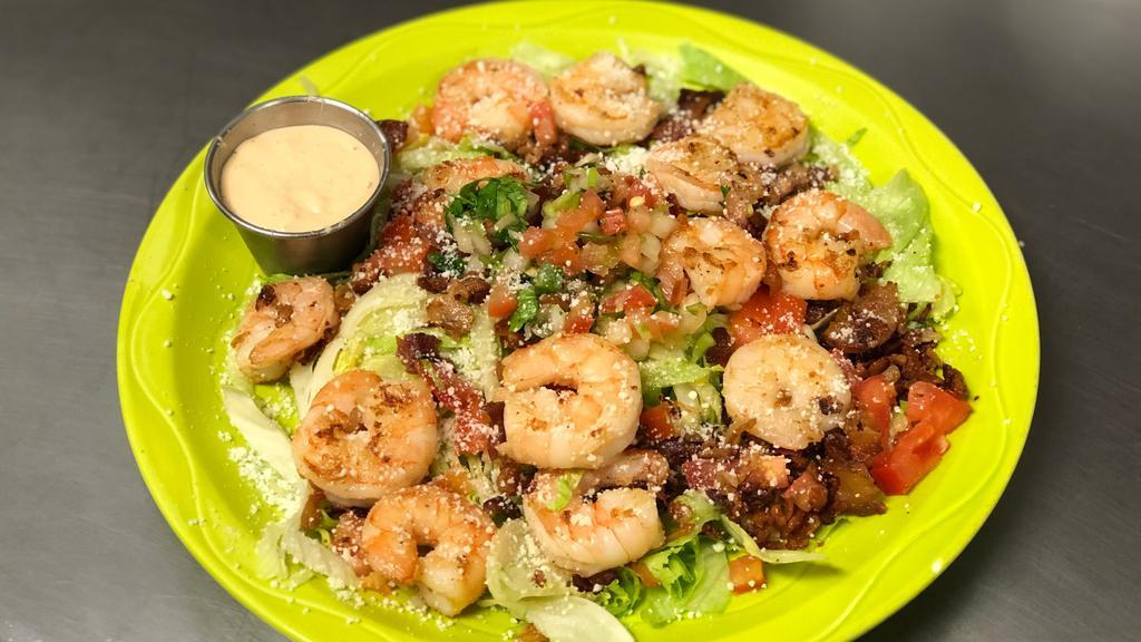 Grilled Shrimp Salad · Grilled shrimp with fresh iceberg lettuce, chopped tomatoes, shredded Cotija cheese, and bacon bits topped with pico de gallo.