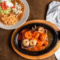 Steak & Camarones · Rib-eye steak and shrimp with ranchero sauce. Served with rice, beans, and guacamole.