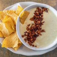Choriqueso And Bag Of Chips · Our melted cheese dip with chorizo (Mexican sausage).