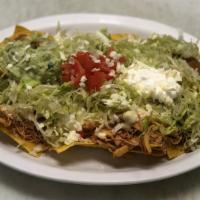 Nacho Supreme · Served with beans, chicken and beef, lettuce, tomatoes, sour cream, and shredded cheese.