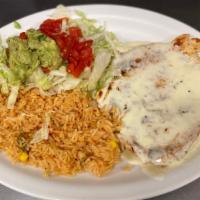 Pollo A La Parrilla · Grilled chicken breast topped with cheese dip and served with rice and guacamole salad.