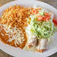 Chimichangas · Two flour tortillas deep-fried and filled with beef tips or chicken. Topped with nacho chees...