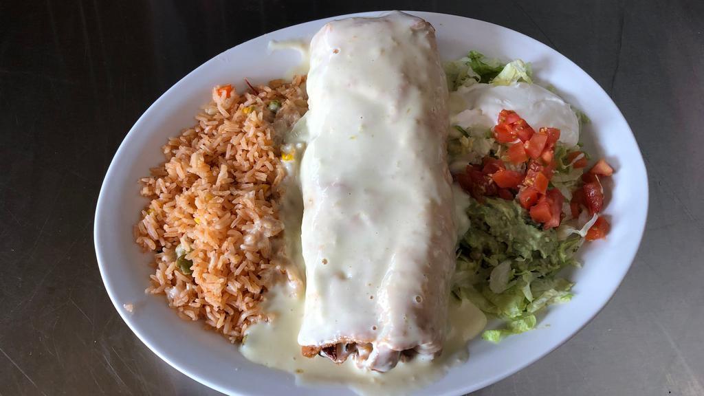 Shrimp Chimichanga · One big chimichanga fried with shrimp, tomatoes, onions and bell peppers. Topped with cheese dip and served with rice and guacamole salad.