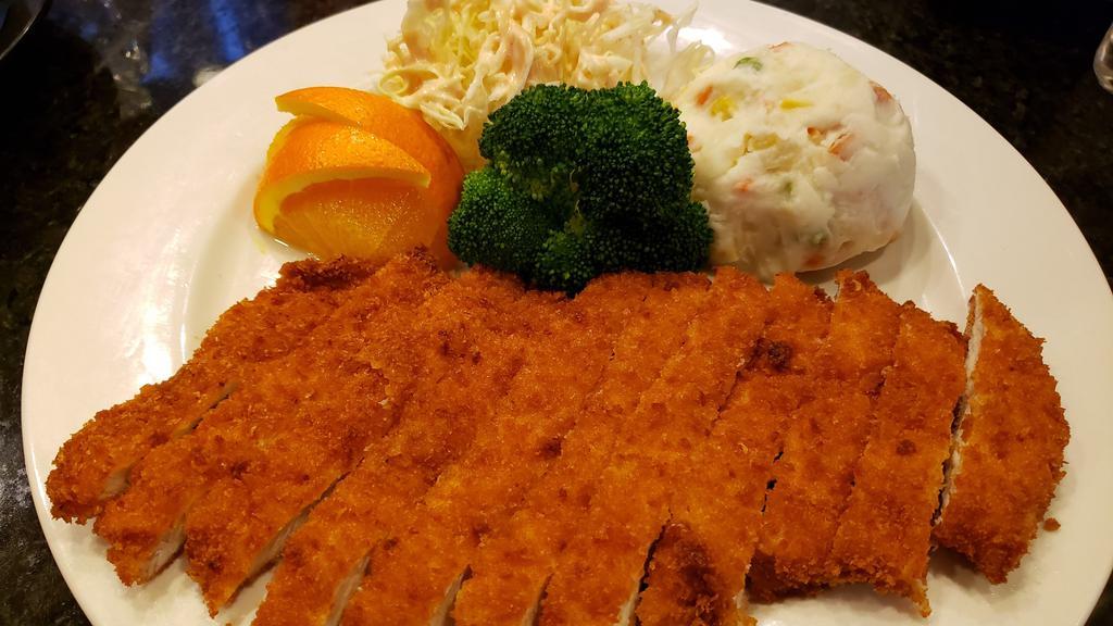 Katsu Dinner · Fried breaded cuts of chicken served with side sauce, vegetables and rice.