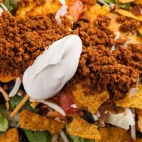 Deluxe Taco Salad · Fresh lettuce topped with taco-seasoned beef, sour cream, nions, tomatoes, black olives, che...