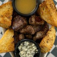 Steak Bites · Tender, grilled steak, with bleu cheese crumbles, zip sauce and garlic bread on the side.