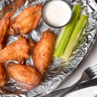 Chicken Wings · Seasoned, baked, and fried, traditional-style wings served with celery and your choice of bl...