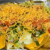 Nacho Grande · Corn tortilla chips smothered with freshly seasoned beef, lettuce, tomato, onion, green pepp...