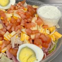 Chef Salad · A bed of crisp lettuce topped with turkey, ham, hard-boiled eggs, fresh tomato, and swiss an...