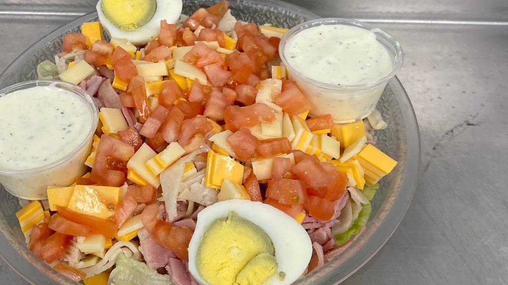 Chef Salad · A bed of crisp lettuce topped with turkey, ham, hard-boiled eggs, fresh tomato, and swiss and American cheese.