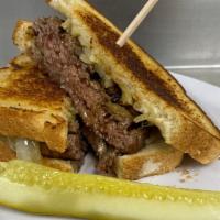 Farm Field Patty Melt · A grilled farm field patty smothered in swiss cheese and grilled onions, served on rye bread.