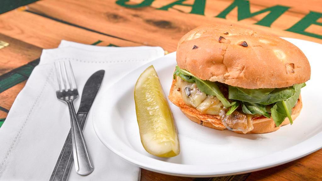 Mighty Gibson · A farm field burger patty, pepper jack cheese, sauteed onions, mushrooms, and jalapeños, topped with fresh spinach on a grilled onion roll.