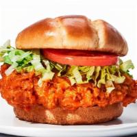 Crispy Chicken Sandwich · Hand-battered and breaded tossed in choice of sauce or dry rub, topped with lettuce and toma...