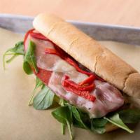 Chourico And Cheese Sandwich · Red Table Chourico, arugula, roasted red peppers, Creamy Herb Aioli and cheese.