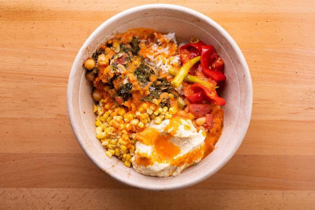 Garden Rice Bowl · Roast red peppers, braised kale and chickpeas, corn, pickled peppers, northern beans and hummus on a bed of herb rice with Red Mojo.