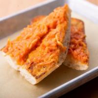 Tomato Garlic Toast · Toasted to order, and topped with fresh grated tomato, olive oil, and garlic. Vegetarian.