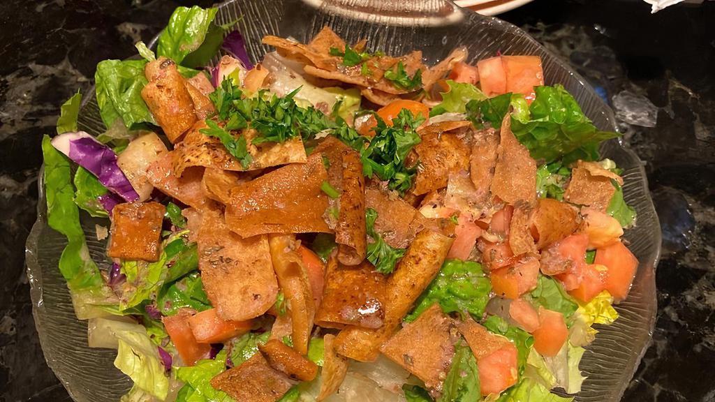 Fattoush · Romaine lettuce, tomato, cucumber, red cabbage topped with crispy pita served with house dressing.