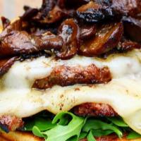 Shroomed Burger · Two fresh patties, roasted mixed mushrooms, melted brie cheese and arugula.
