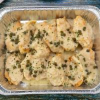 Chicken Limone · Chicken breasts sauteed with garlic and capers in a white wine lemon sauce, served over a be...
