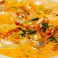 Ravioli Florentine · Jumbo spinach-filled ravioli simmered with scallion and fresh mushrooms in a sun-dried tomat...