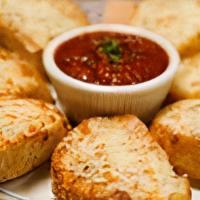 Cottage Inn Cheesebread · Fresh baked bread brushed with garlic herb olive oil, topped with Parmesan and mozzarella ch...