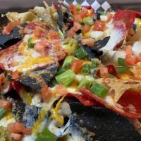 Cottage Inn Nachos · Homemade tortilla chips baked with mozzarella, cheddar, black beans, and jalapeño. Topped wi...