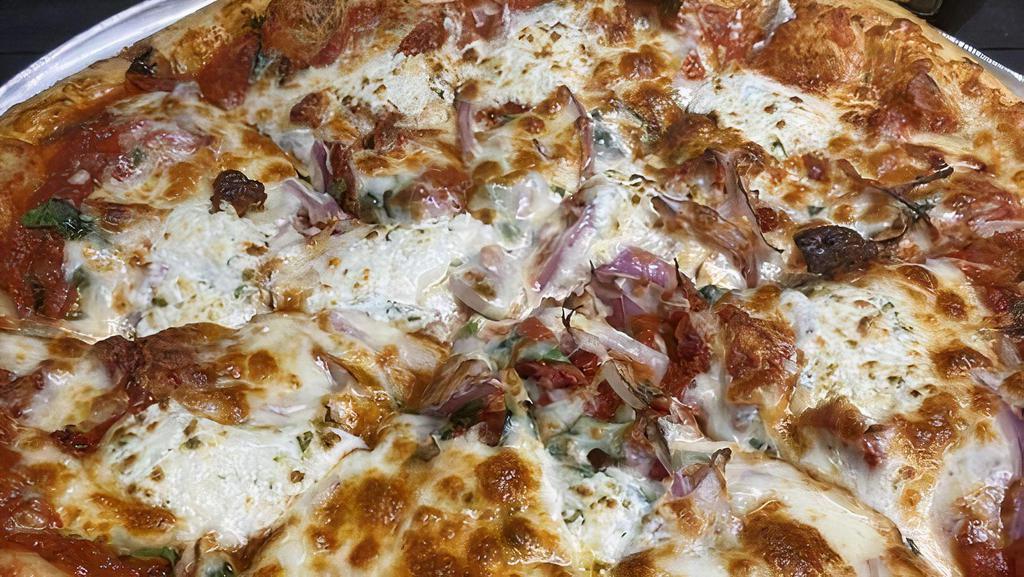Pizza Florentine · Fresh spinach, sun-dried tomato, goat cheese, red onion, and mozzarella.  Sprinkled with Italian herbs and finished with extra virgin olive oil.