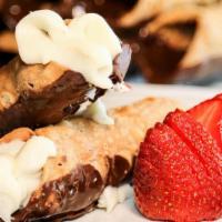 Cannoli · Traditional Italian pastry with sweet ricotta filling, hand dipped in belgian chocolate.