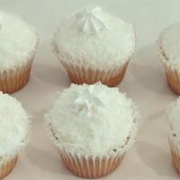 Coconut · Vanilla cake with vanilla icing and sweetened coconut flakes on top.