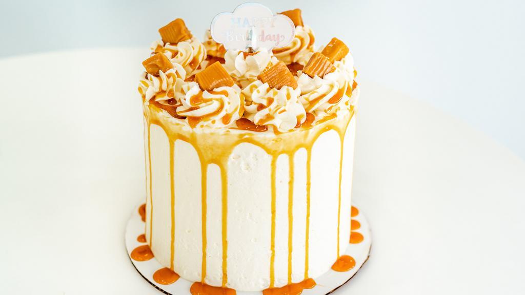 Caramel Delight Cake · 6-inch Vanilla cake with dulce de leche filling and Italian buttercream icing.  Topped with a caramel drizzle. Serves 8-10.