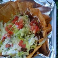 Taco Salad · Crisp flour tortilla shell with your choice of ground beef or chicken, lettuce, beans, tomat...