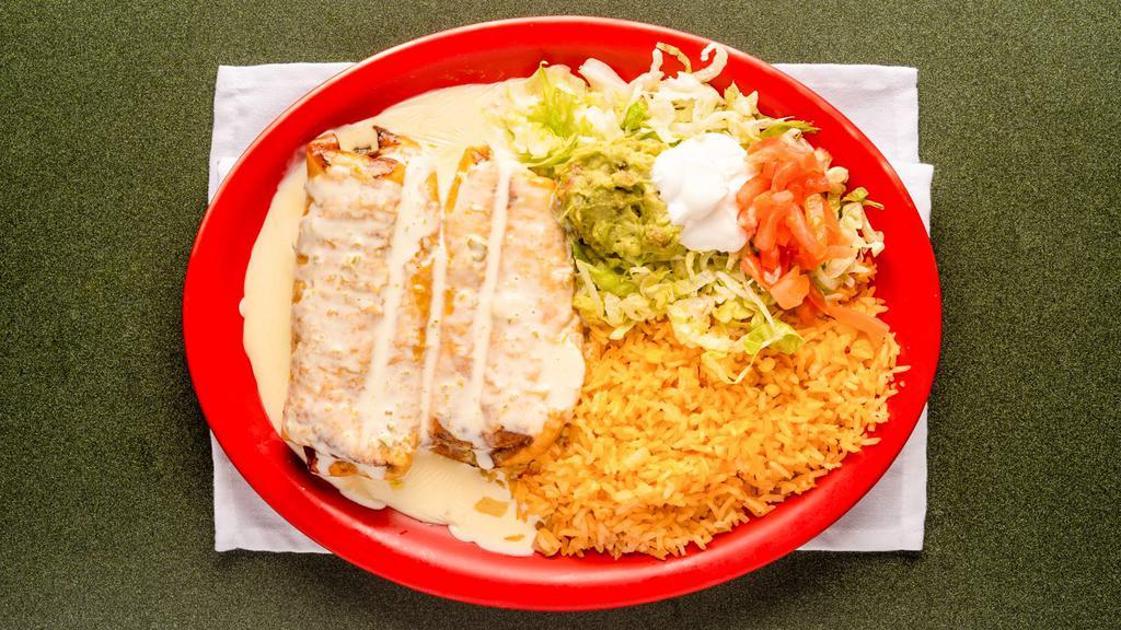 Chimichangas · Two chimichangas stuffed with your choice of chicken, ground beef or shredded beef, deep fried, topped with nacho sauce and served with tomatoes, sour cream, guacamole, lettuce, rice or beans.