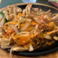 Fajitas · Your choice of chicken or steak, sautéed with onions, bell peppers and tomatoes. Served with...