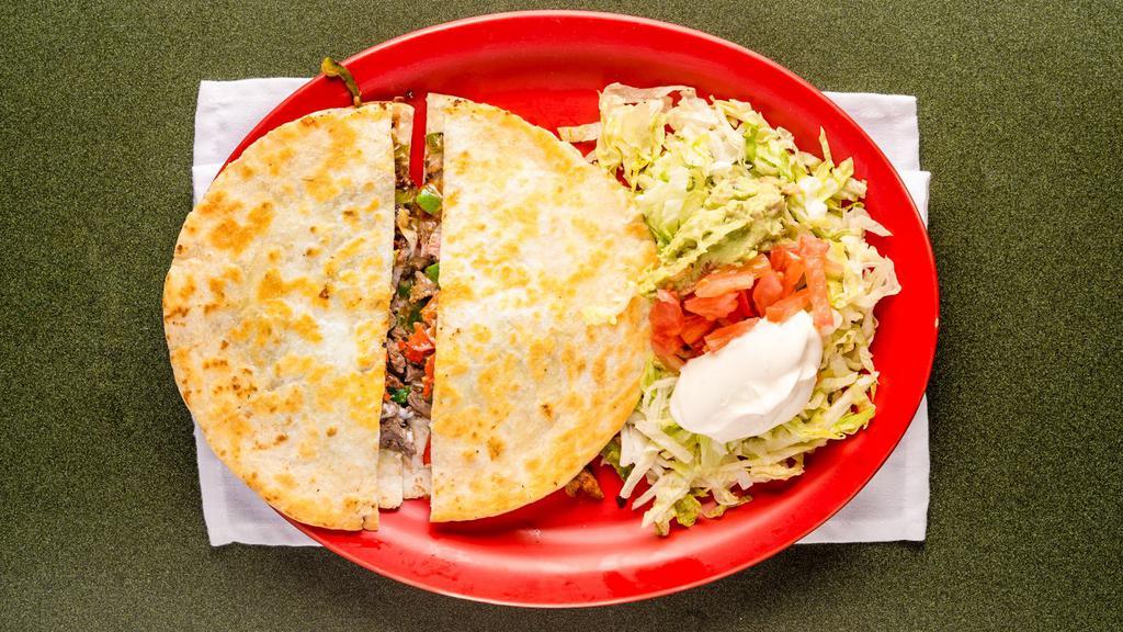 Quesadilla Ranchera · Your choice of steak or chicken served with onions, tomatoes, bell pepper and guacamole salad.
