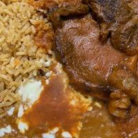 Steak Ranchero · Steak with ranchero sauce, served with rice and beans.